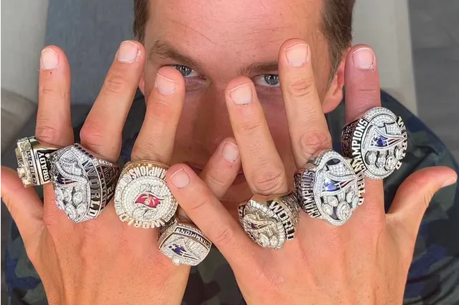 Tom Brady with a whole lot of rings