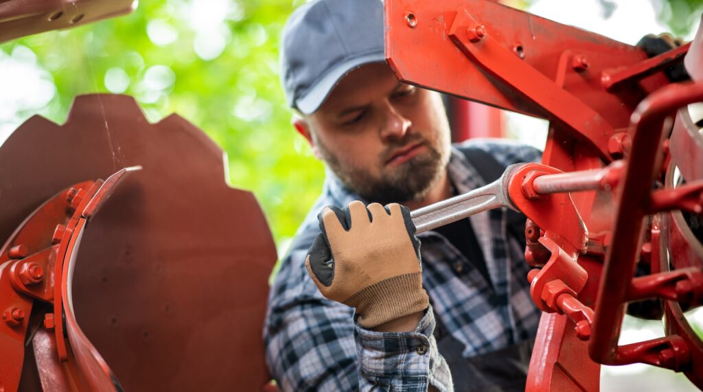 man repairing tractor
